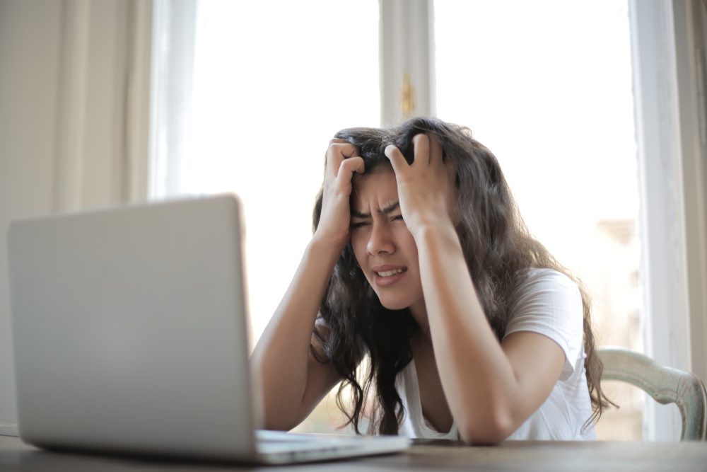 frustrated woman using her laptop