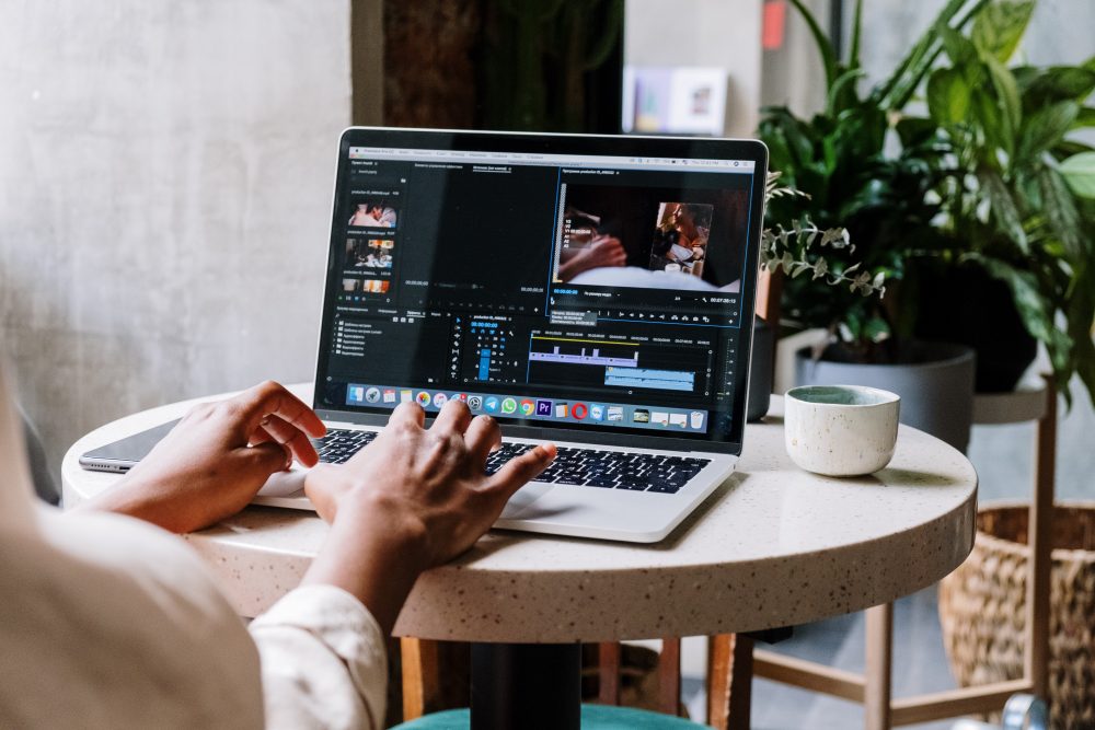 a person using premiere pro on a macbook